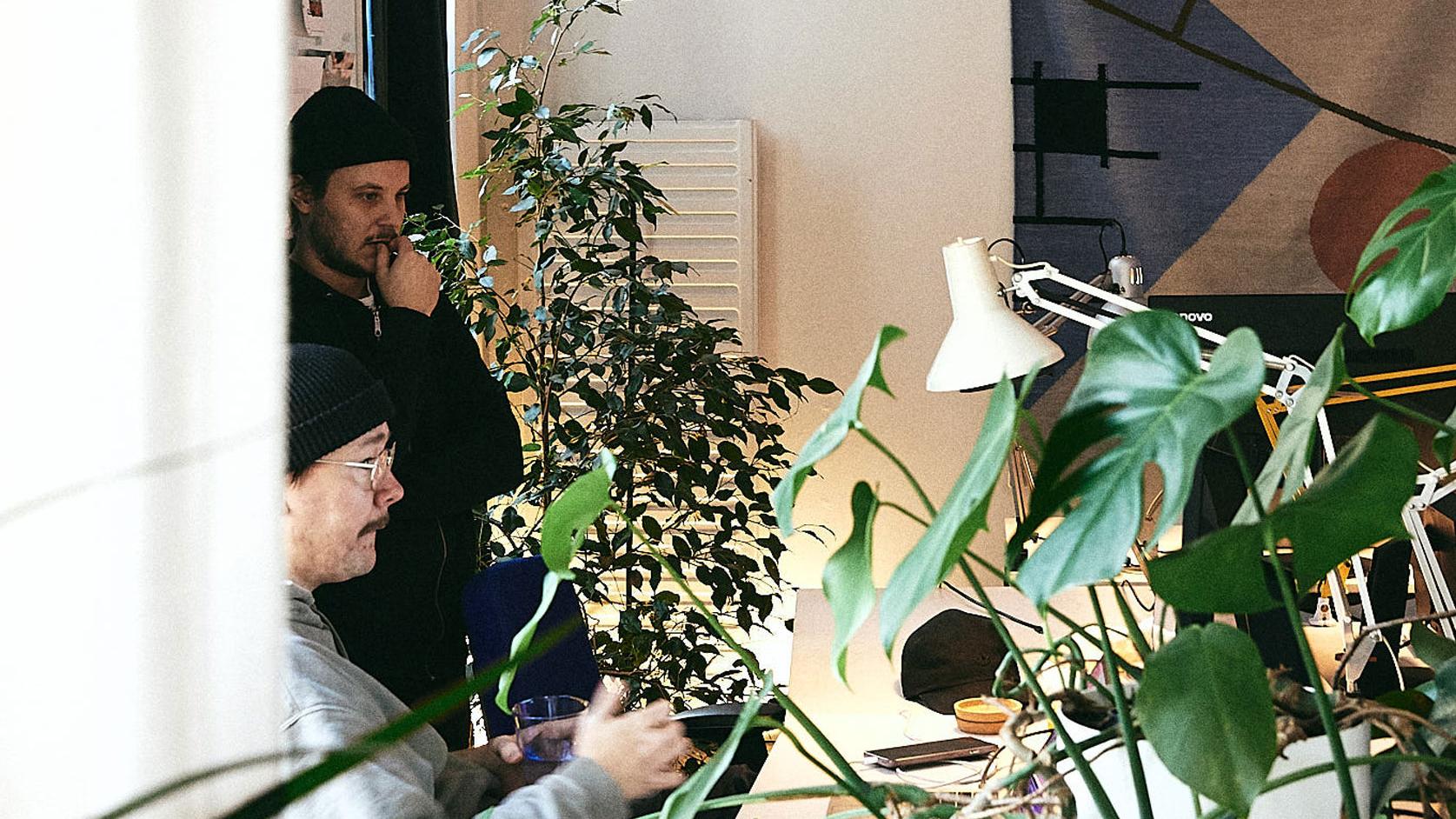 Two men looking at a computer screen in an office
