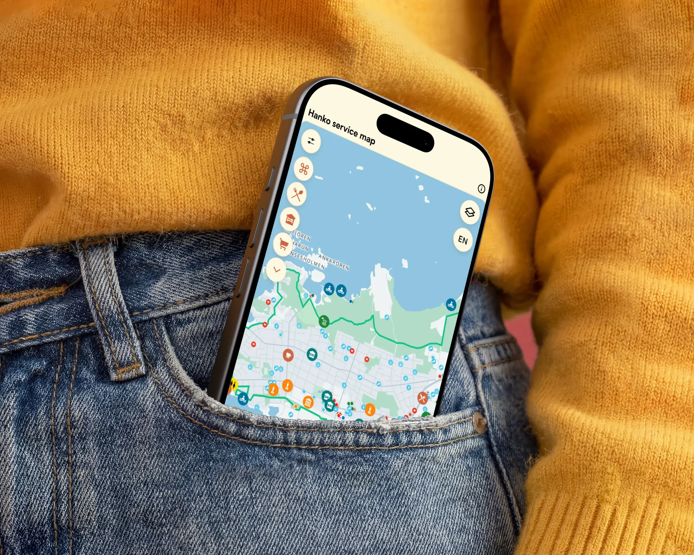 Phone in a jeans pocket showing the Hanko service map built with Zoneatlas